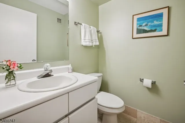 a bathroom with a sink mirror and toilet
