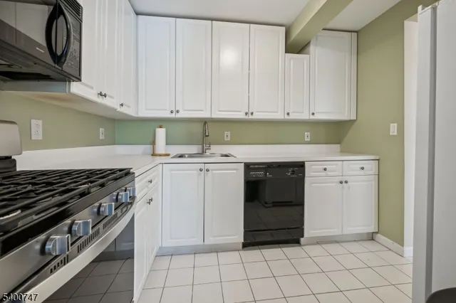 a kitchen with a stove sink and cabinets