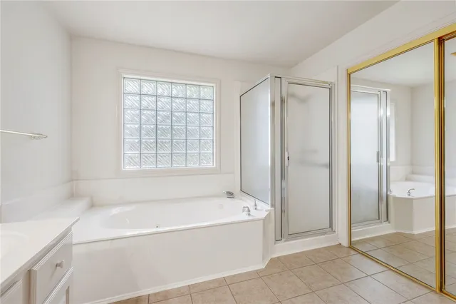 a bathroom with a bathtub and a shower