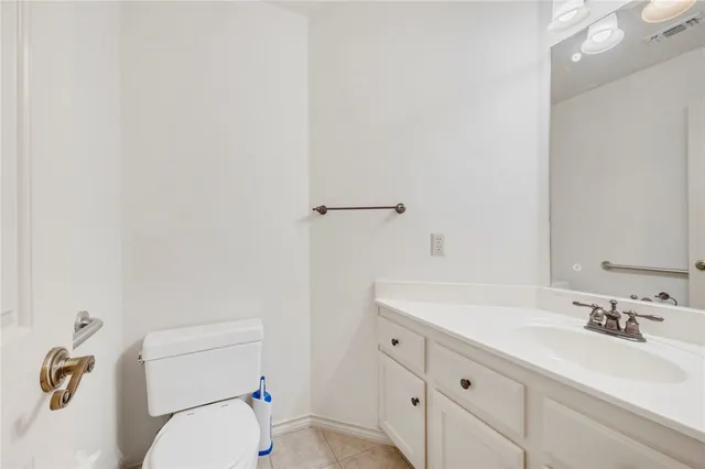 a bathroom with a sink a toilet and vanity