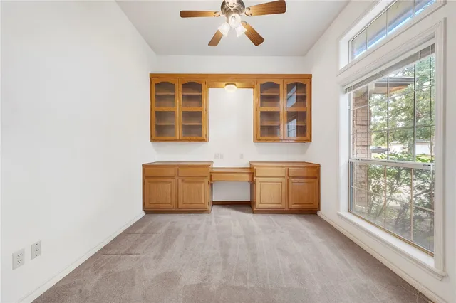 a living room with a large window and chandelier