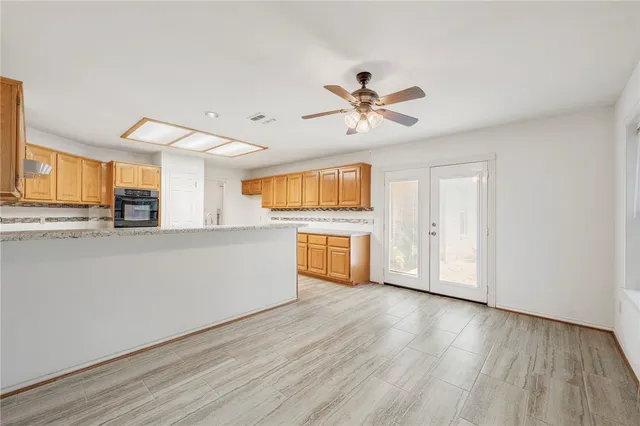 a view of a kitchen with a dishwasher cabinets and wooden floor