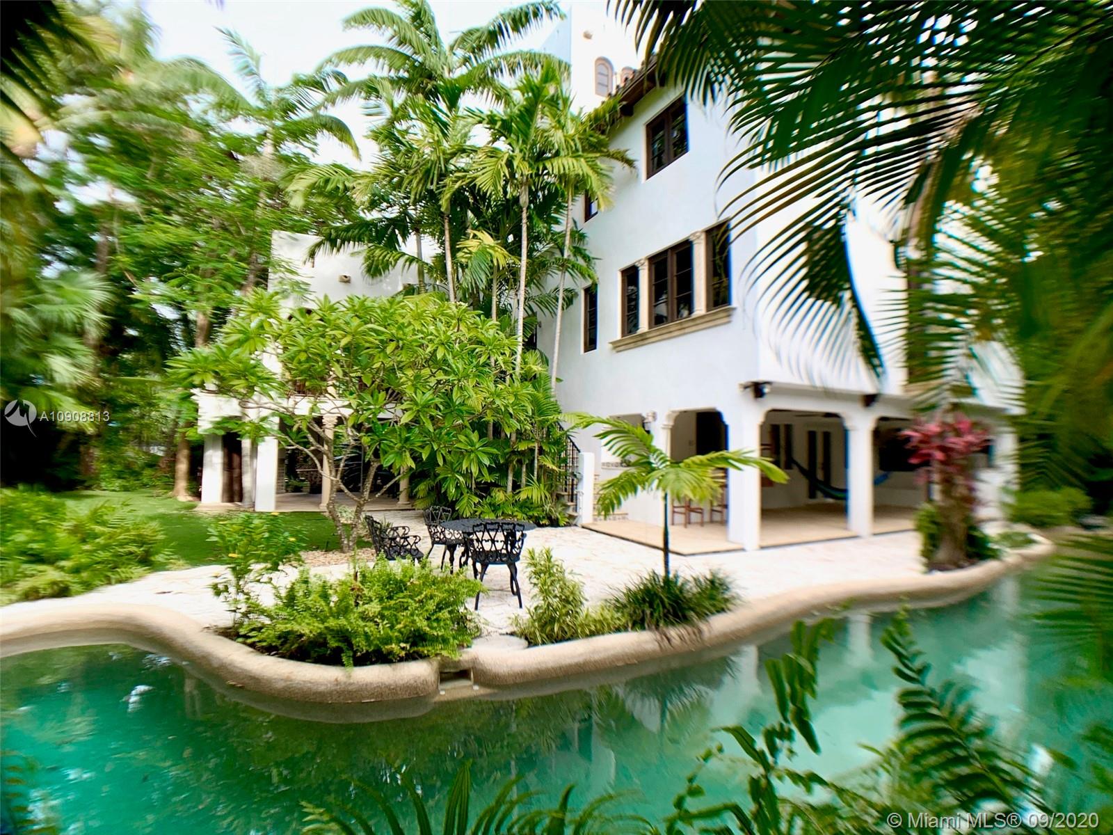 a front view of a house with garden and porch