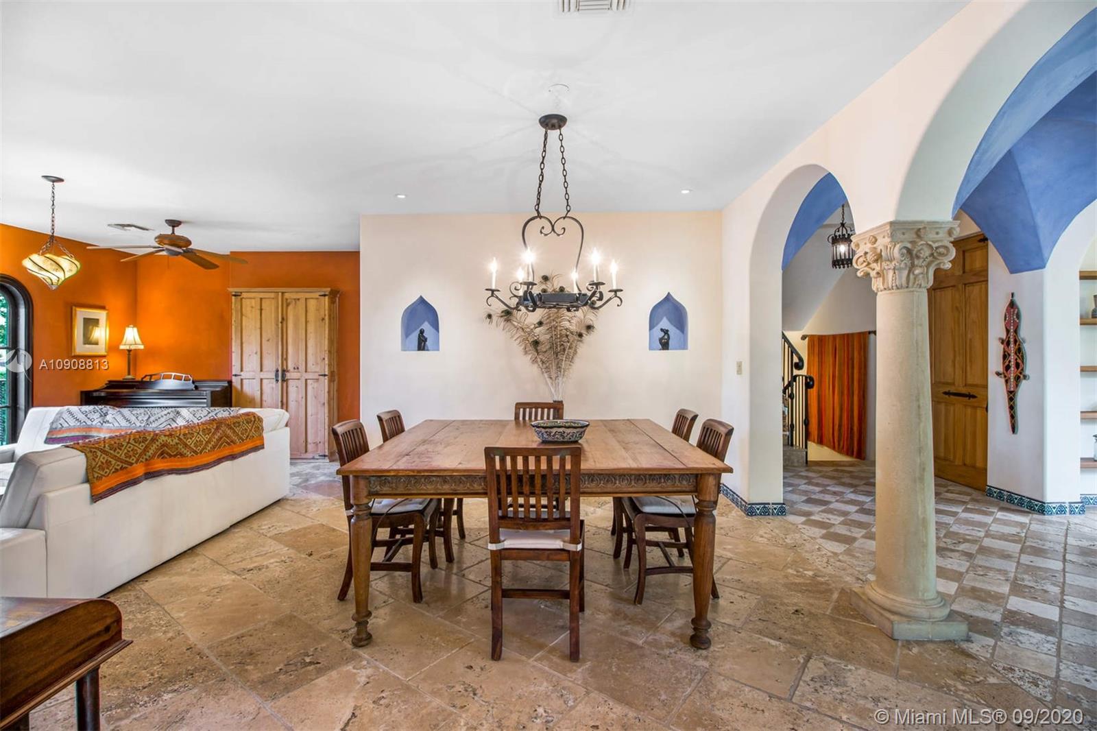 385 Ridgewood Road Key Biscayne, FL 33149 - Photo 11 of 54 a view of a dining room with furniture and chandelier