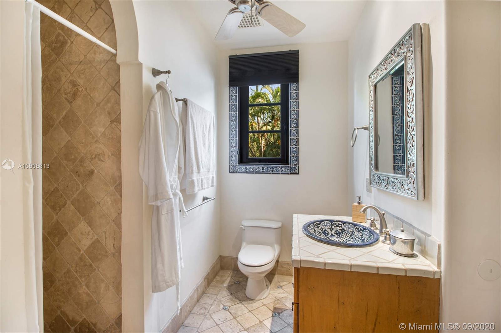 385 Ridgewood Road Key Biscayne, FL 33149 - Photo 14 of 54 a bathroom with a granite countertop sink toilet and shower