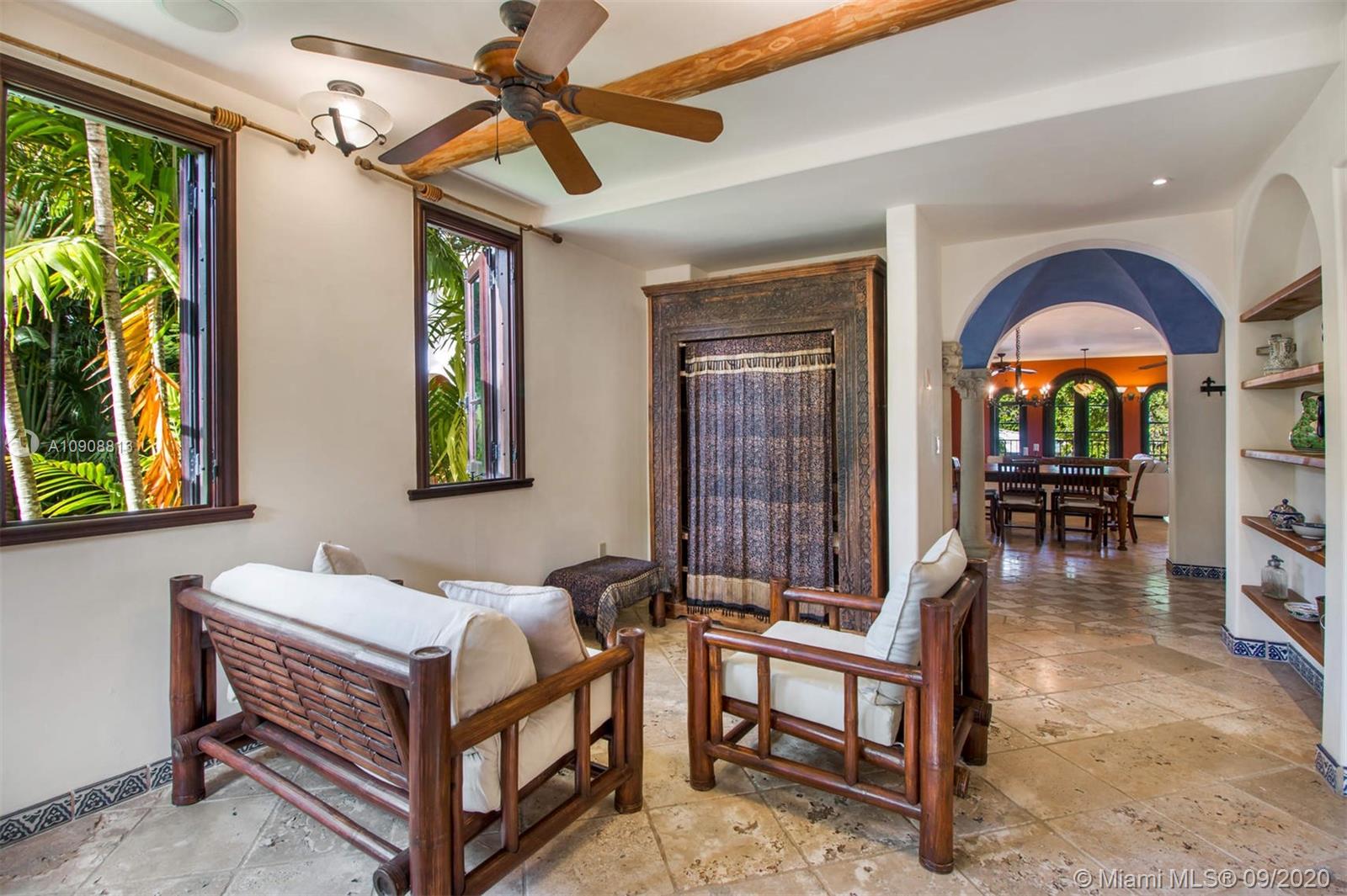 385 Ridgewood Road Key Biscayne, FL 33149 - Photo 18 of 54 a bedroom with a bed a dresser and windows