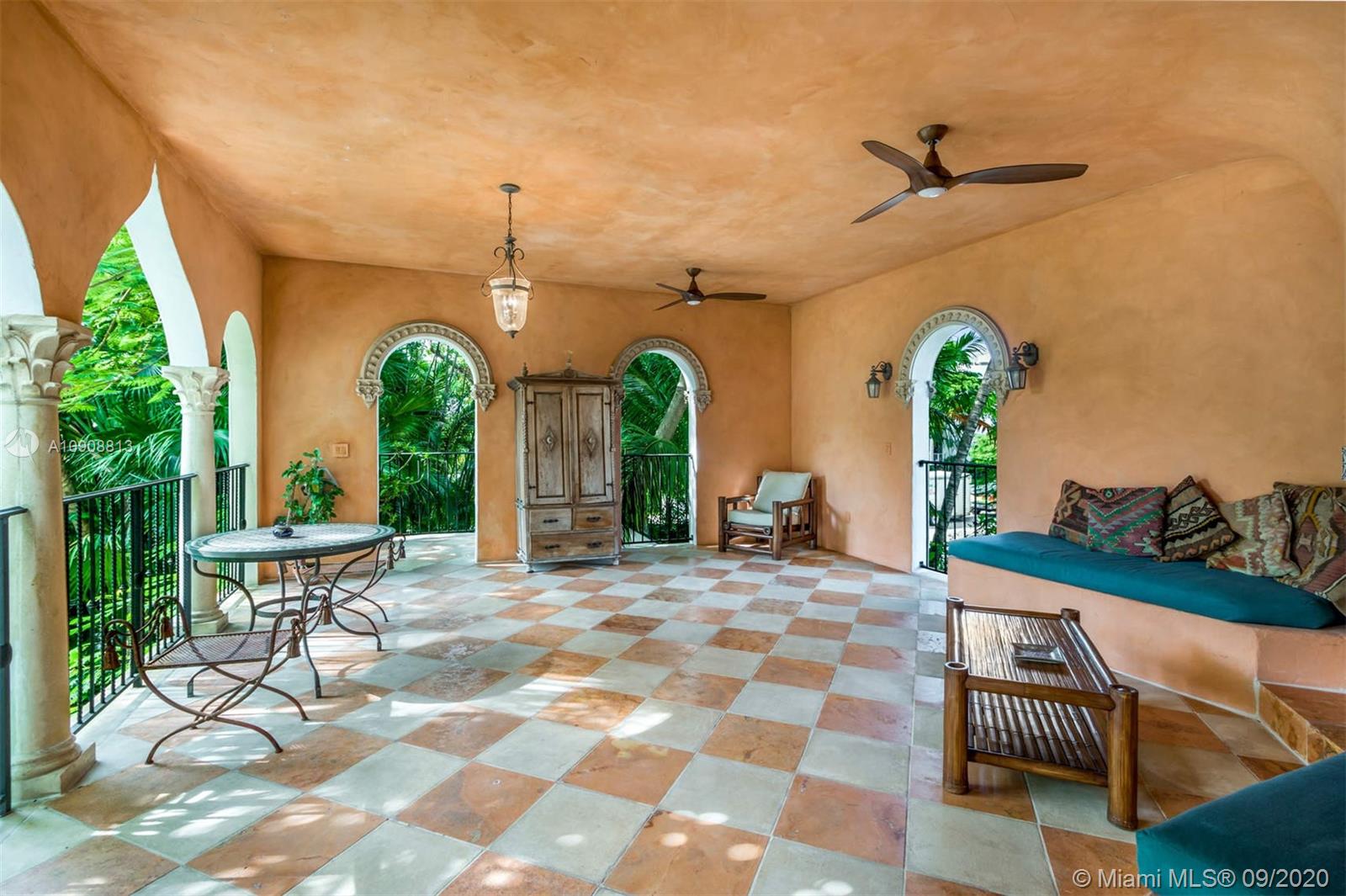 385 Ridgewood Road Key Biscayne, FL 33149 - Photo 21 of 54 a view of a chairs and table in patio