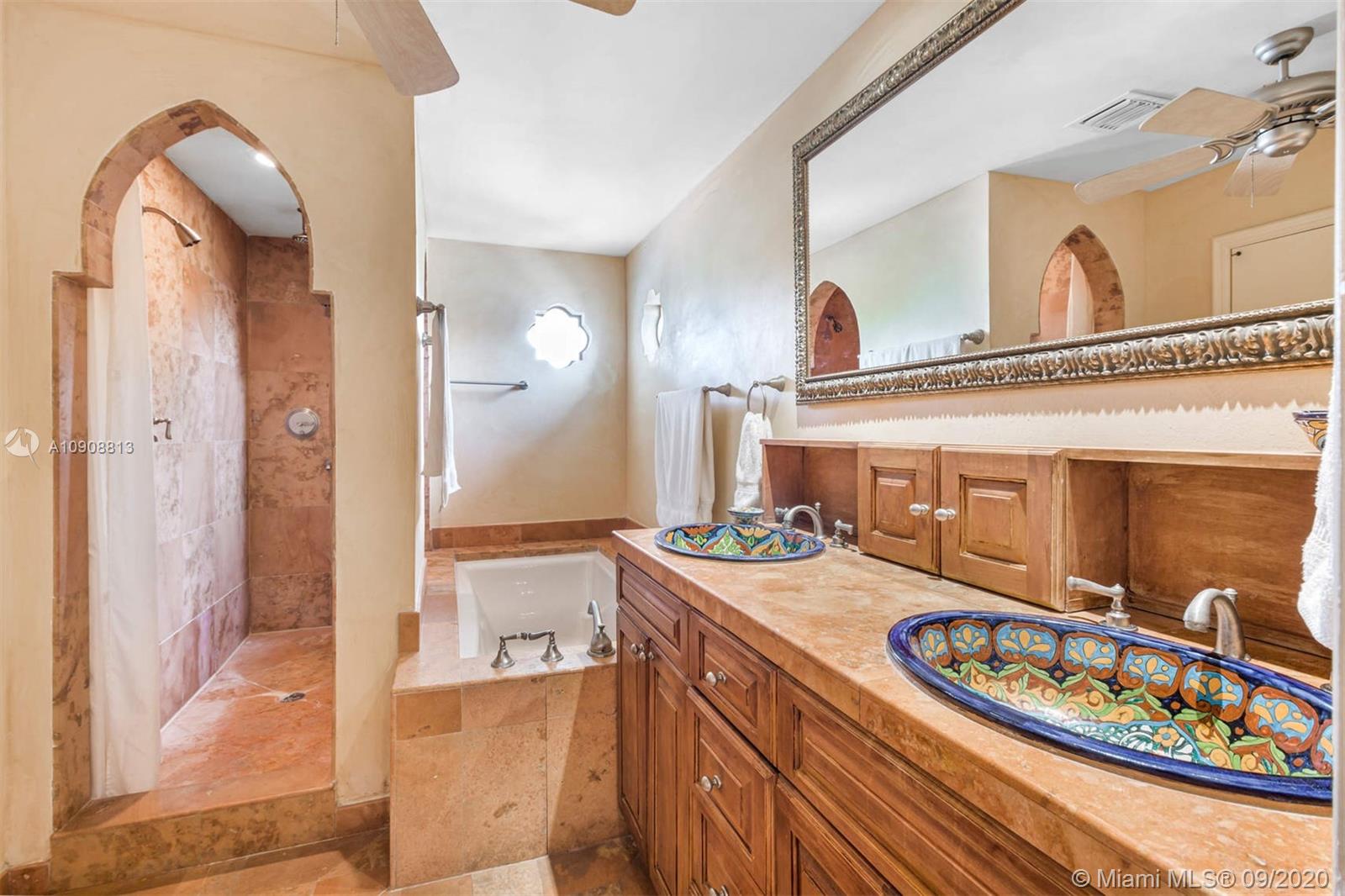 385 Ridgewood Road Key Biscayne, FL 33149 - Photo 30 of 54 a bathroom with a sink a mirror and a shower