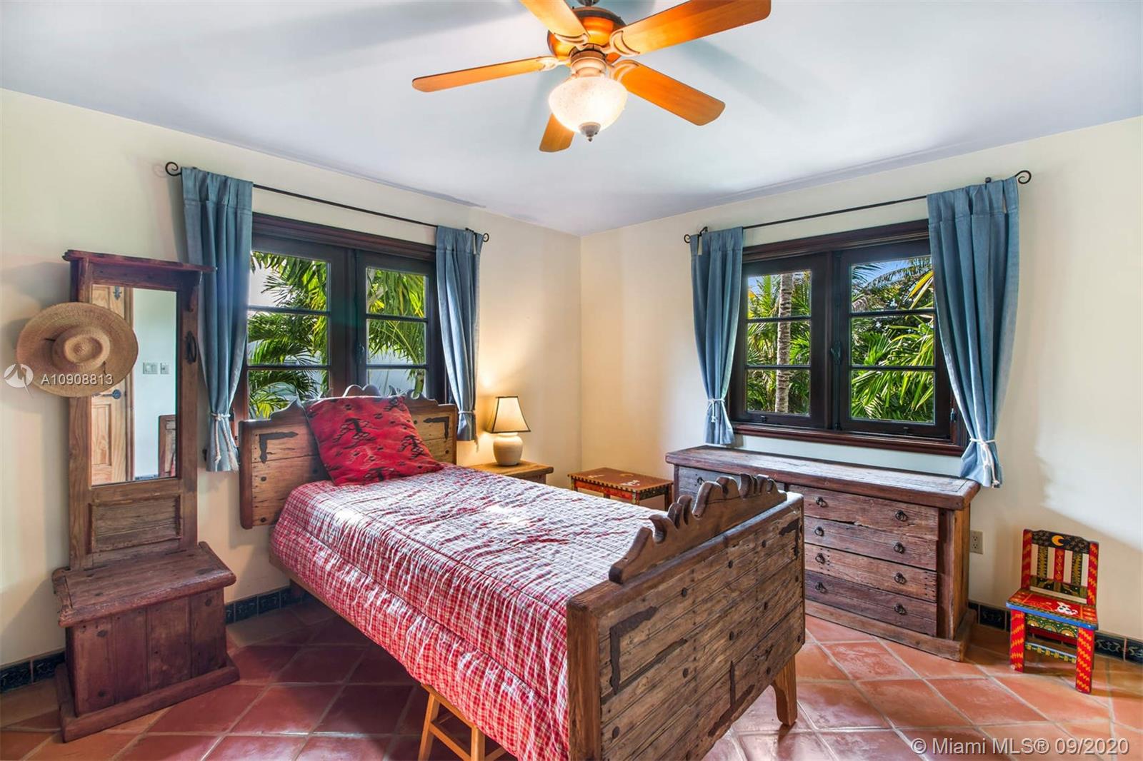 385 Ridgewood Road Key Biscayne, FL 33149 - Photo 31 of 54 a bedroom with a bed and a chandelier