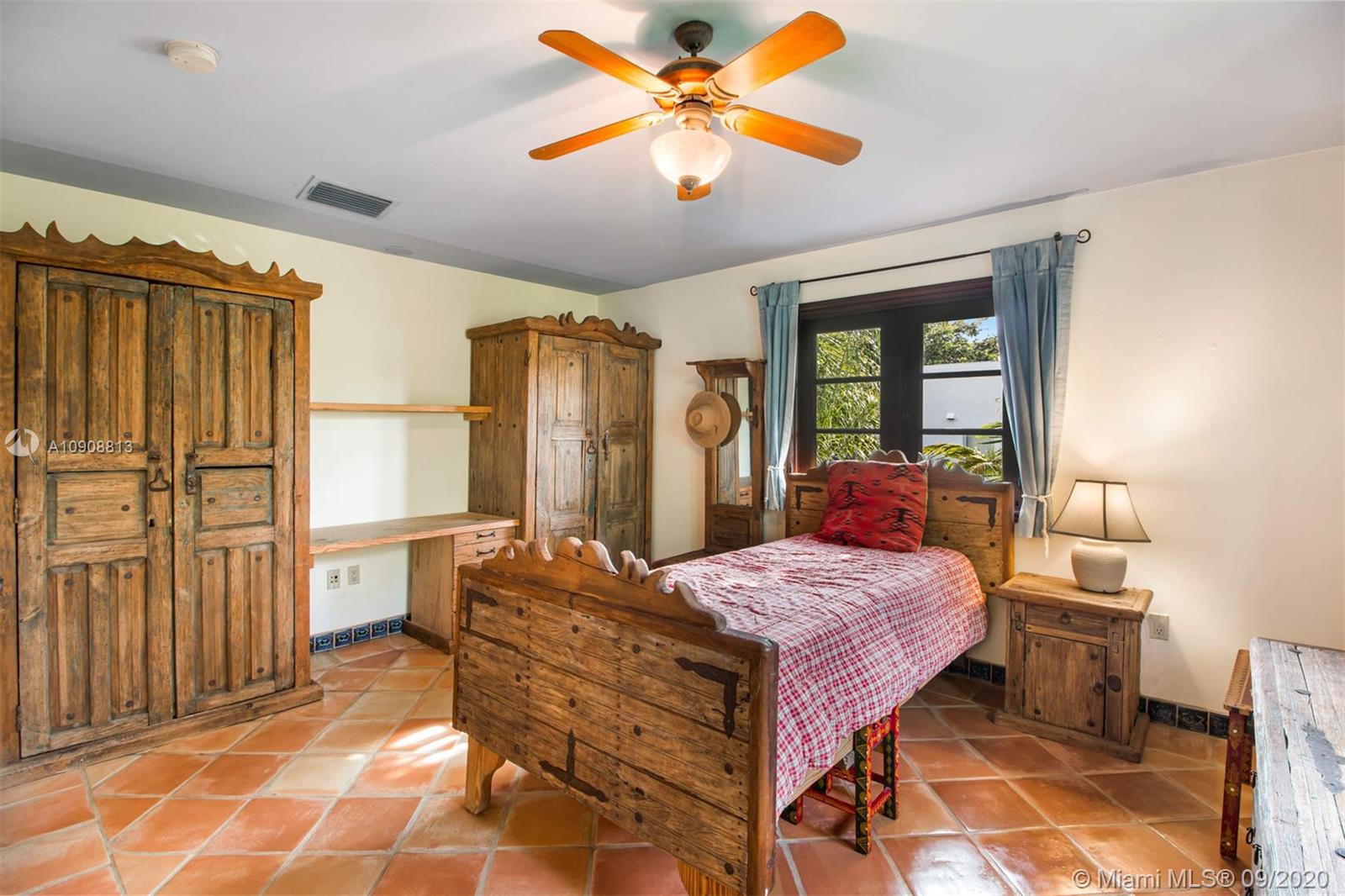 385 Ridgewood Road Key Biscayne, FL 33149 - Photo 32 of 54 a bedroom with a bed and a chandelier