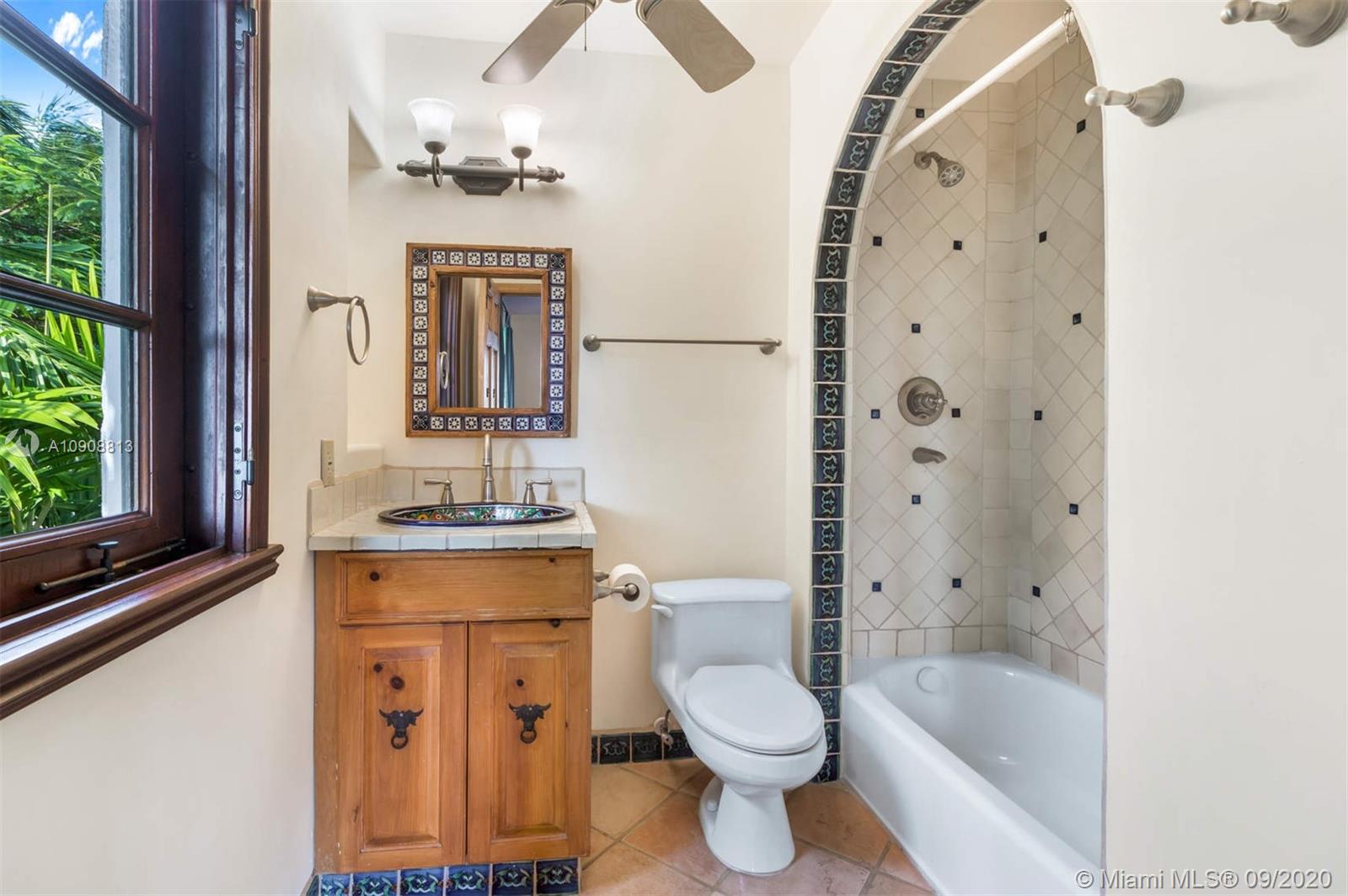 385 Ridgewood Road Key Biscayne, FL 33149 - Photo 33 of 54 a bathroom with a granite countertop toilet a sink and a mirror