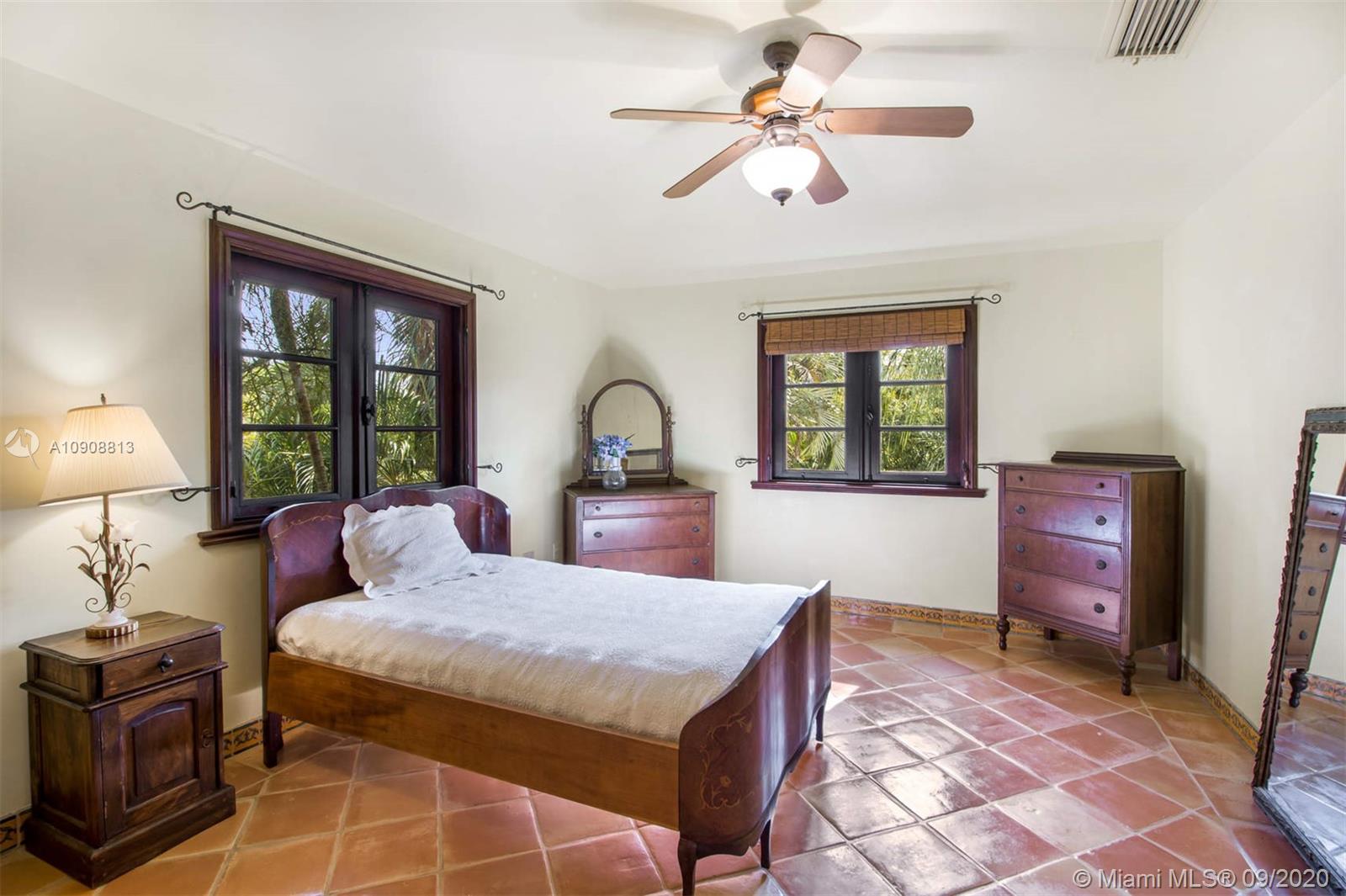 385 Ridgewood Road Key Biscayne, FL 33149 - Photo 34 of 54 a living room with furniture a window and a chandelier
