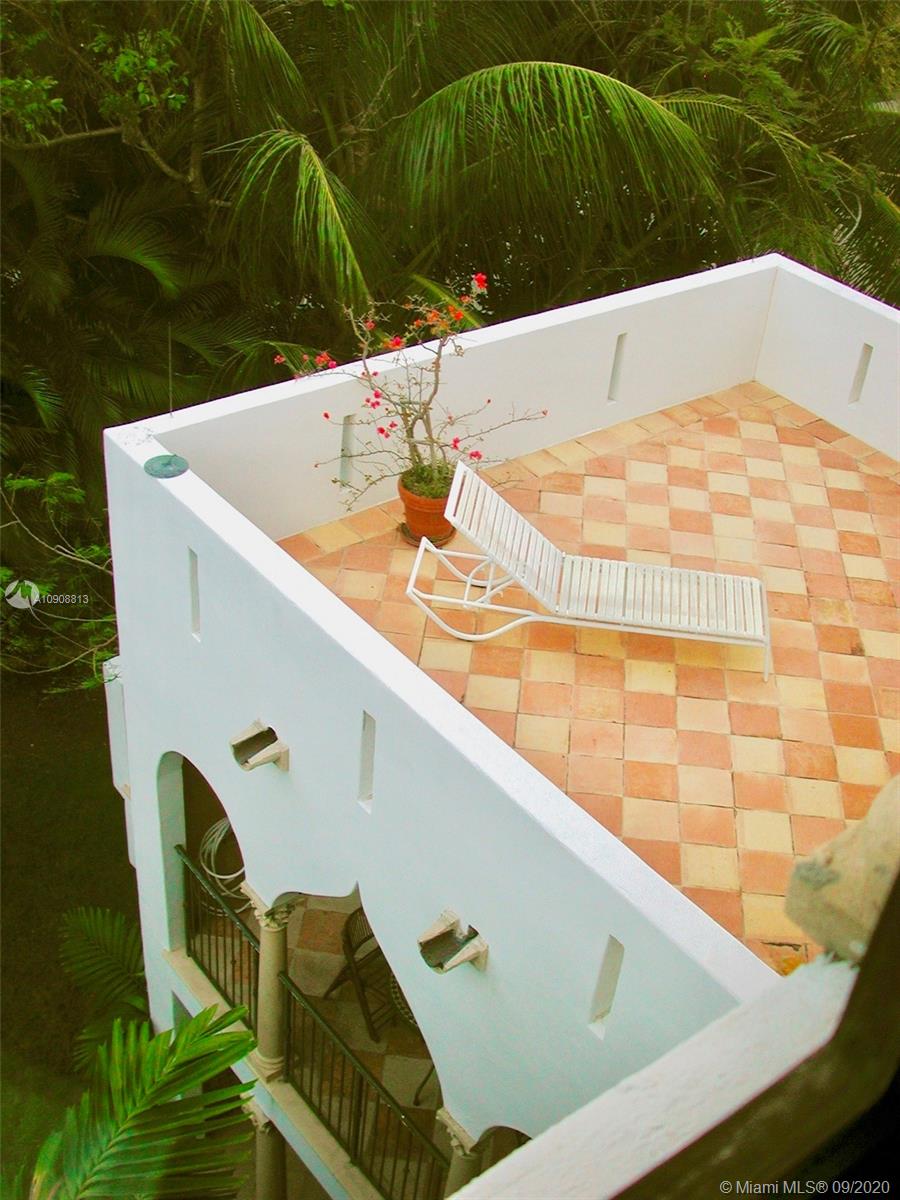 385 Ridgewood Road Key Biscayne, FL 33149 - Photo 37 of 54 a terrace with outdoor seating and wooden floor