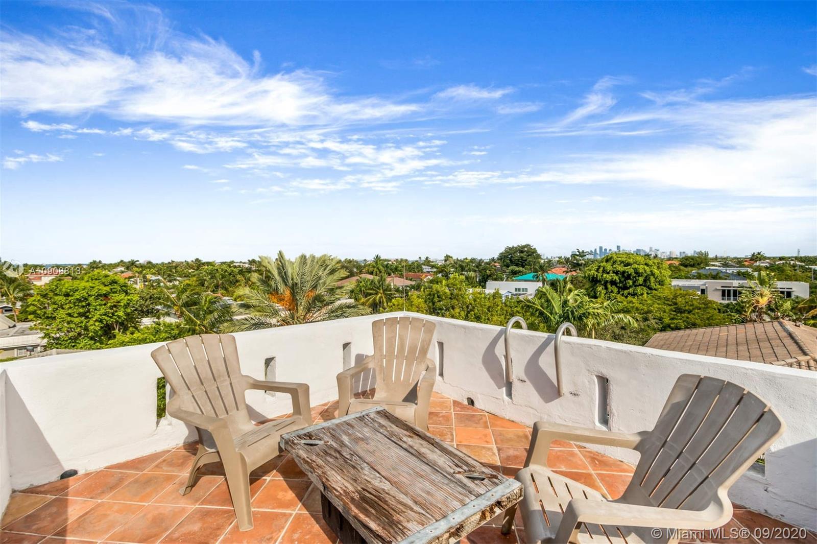 385 Ridgewood Road Key Biscayne, FL 33149 - Photo 38 of 54 a view of a patio with a table