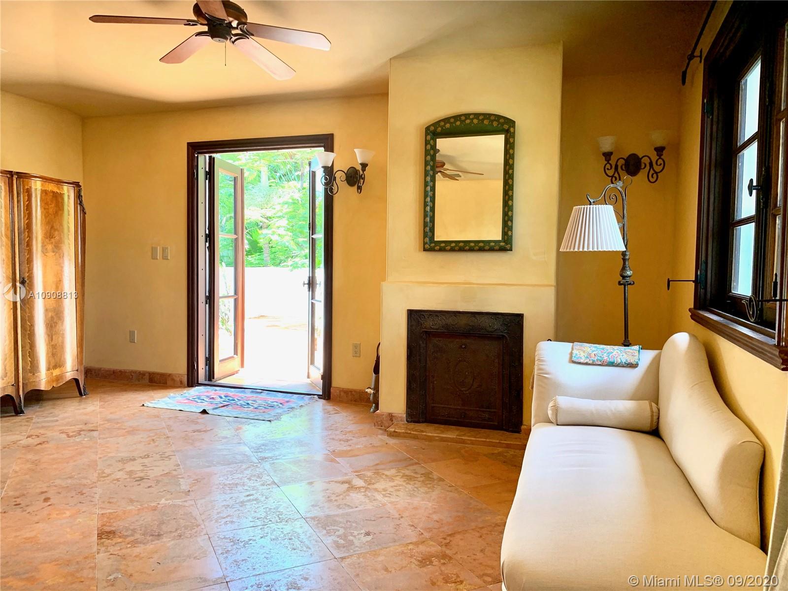 385 Ridgewood Road Key Biscayne, FL 33149 - Photo 54 of 54 a living room with furniture and a fireplace