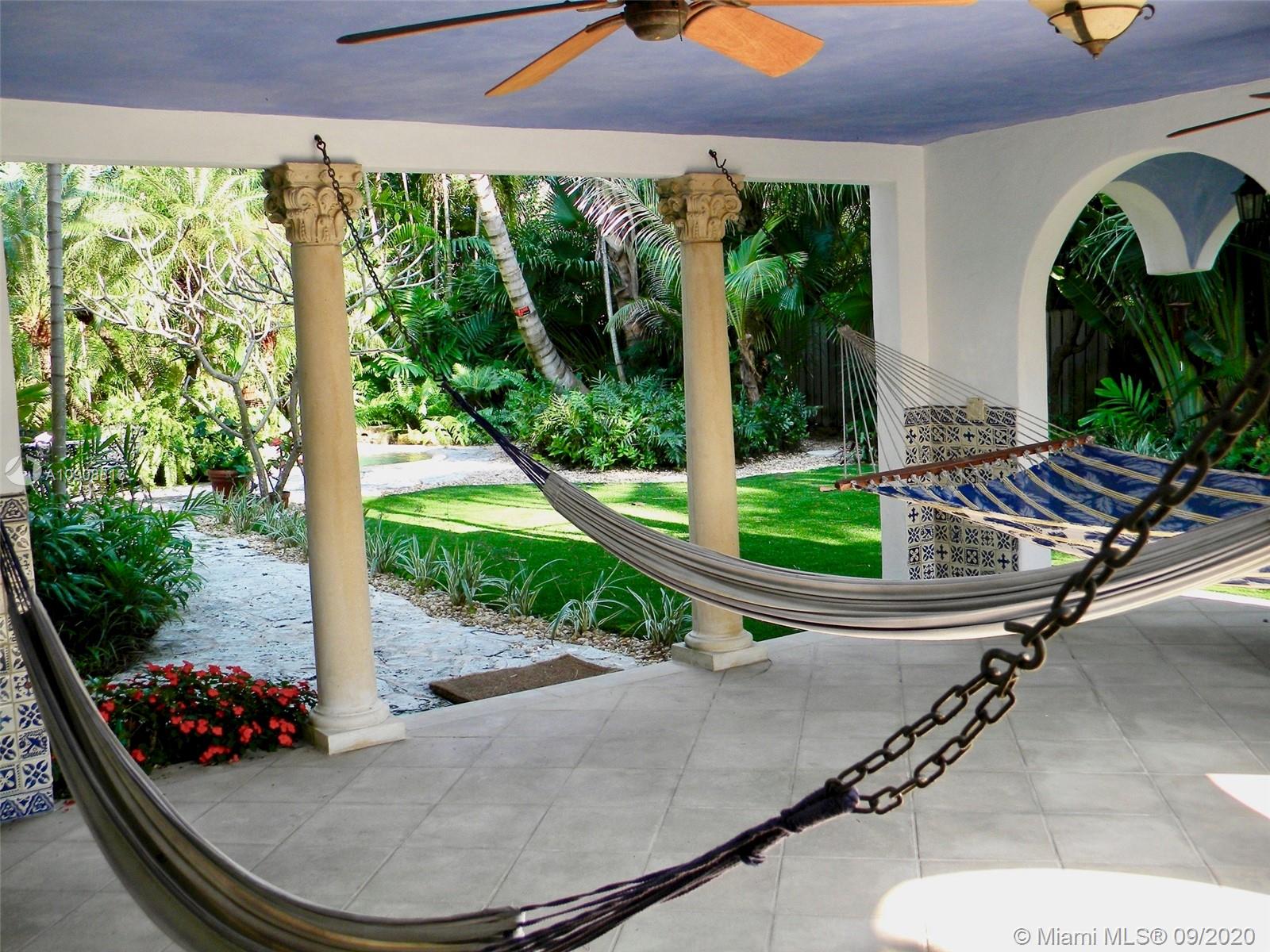 385 Ridgewood Road Key Biscayne, FL 33149 - Photo 6 of 54 a front view of a house with garden