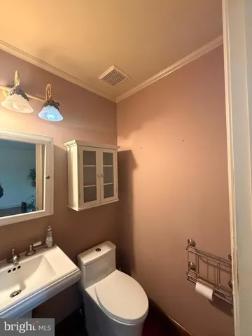 a bathroom with a sink mirror vanity and toilet