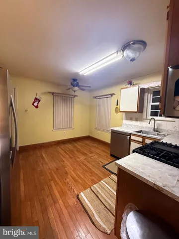 a view of a kitchen with kitchen island and stainless steel appliances