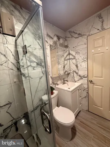 a bathroom with a sink toilet and shower