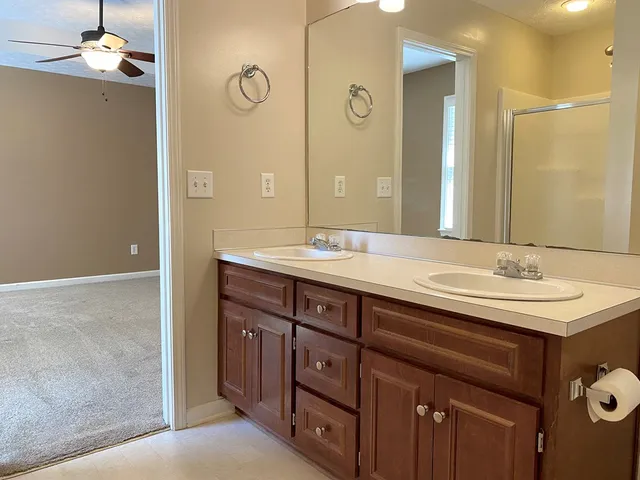 a bathroom with a double vanity sink and a mirror