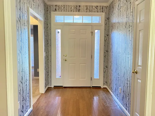 a view of a hallway with wooden floor
