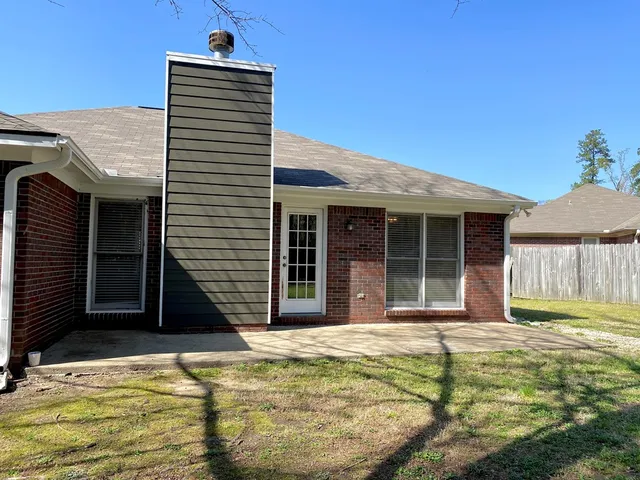 a view of a house with a backyard