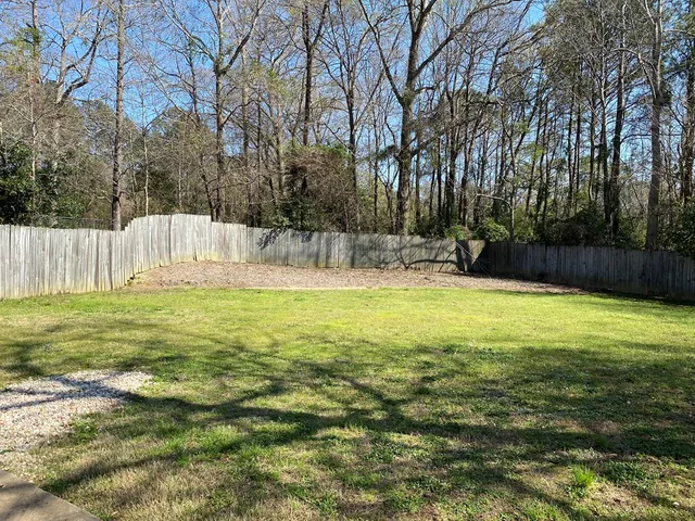 a view of outdoor space with garden and trees