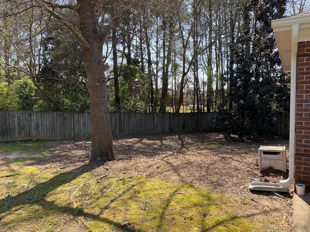 a backyard of a house with lots of green space