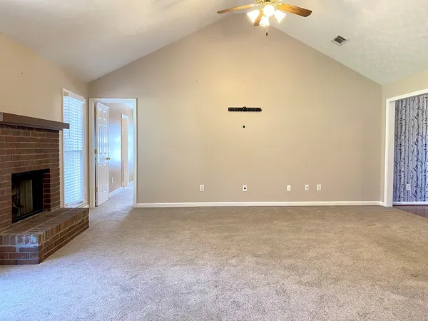 a view of an empty room with a fireplace