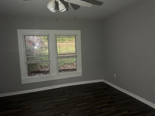 98 5th Street Calhoun, GA 30701 - Photo 4 of 9 a view of an empty room with wooden floor and a window