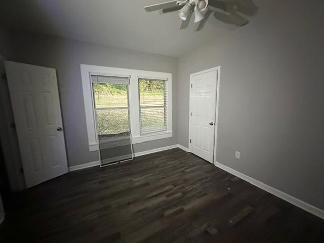 98 5th Street Calhoun, GA 30701 - Photo 6 of 9 a view of an empty room with wooden floor and a window