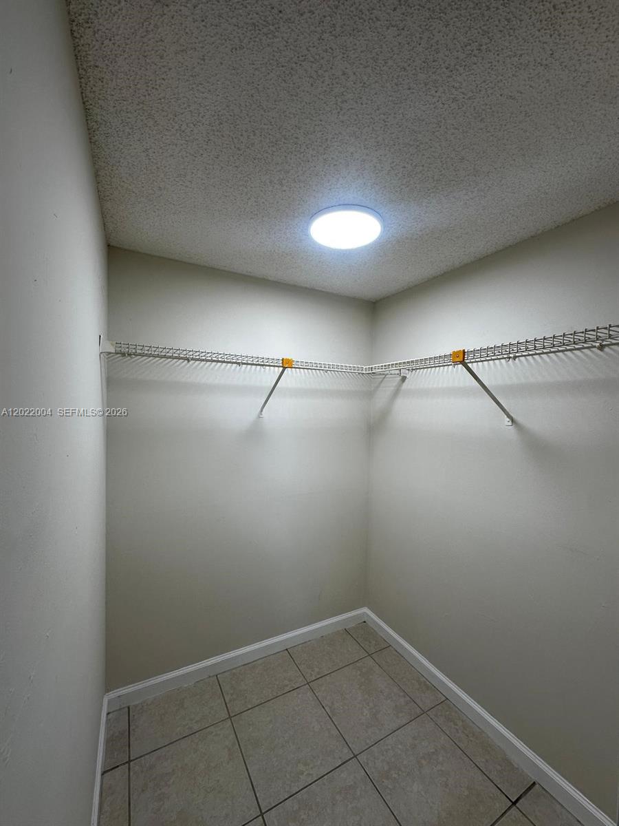 3400 Foxcroft Road, Unit 301 Miramar, FL 33025 - Photo 45 of 72 a view of a room with racks on the wall