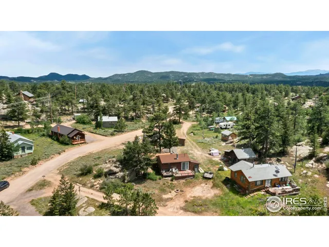 a view of a roof deck with table and chairs with wooden floor and fence