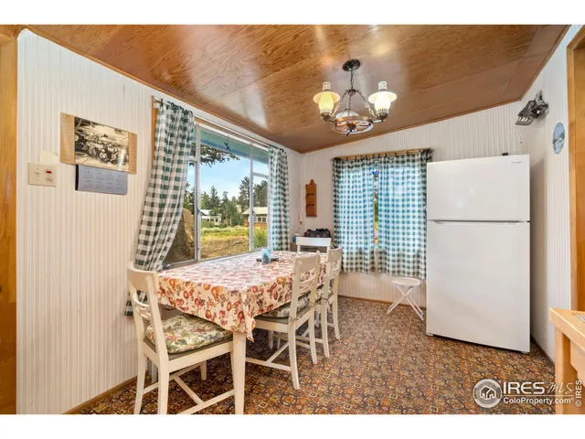 a bedroom with a bed dresser and a large window