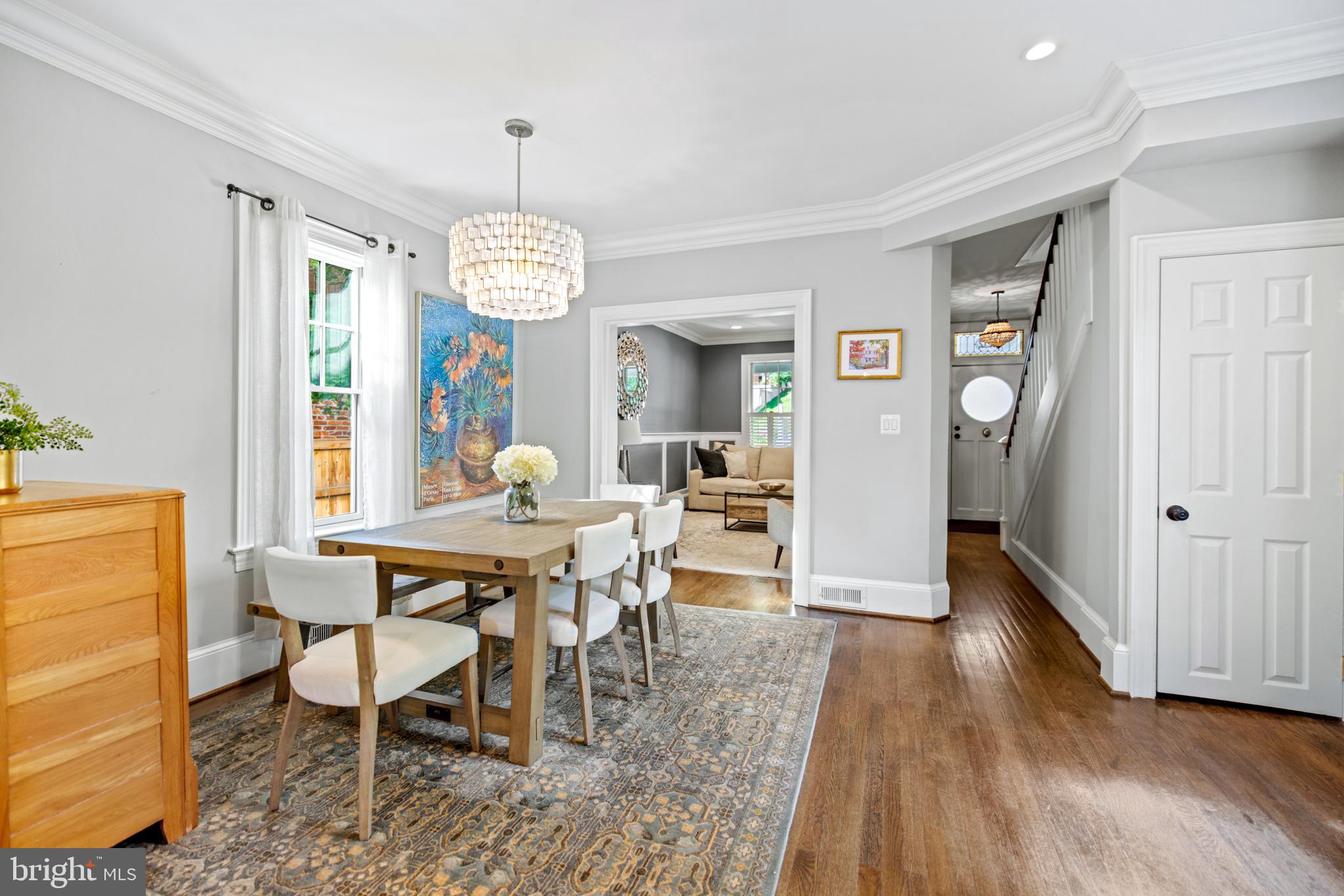 5212 MacArthur Boulevard Northwest Washington, DC 20016 - Photo 13 of 59 a dining room with wooden floor a chandelier a wooden table and chairs