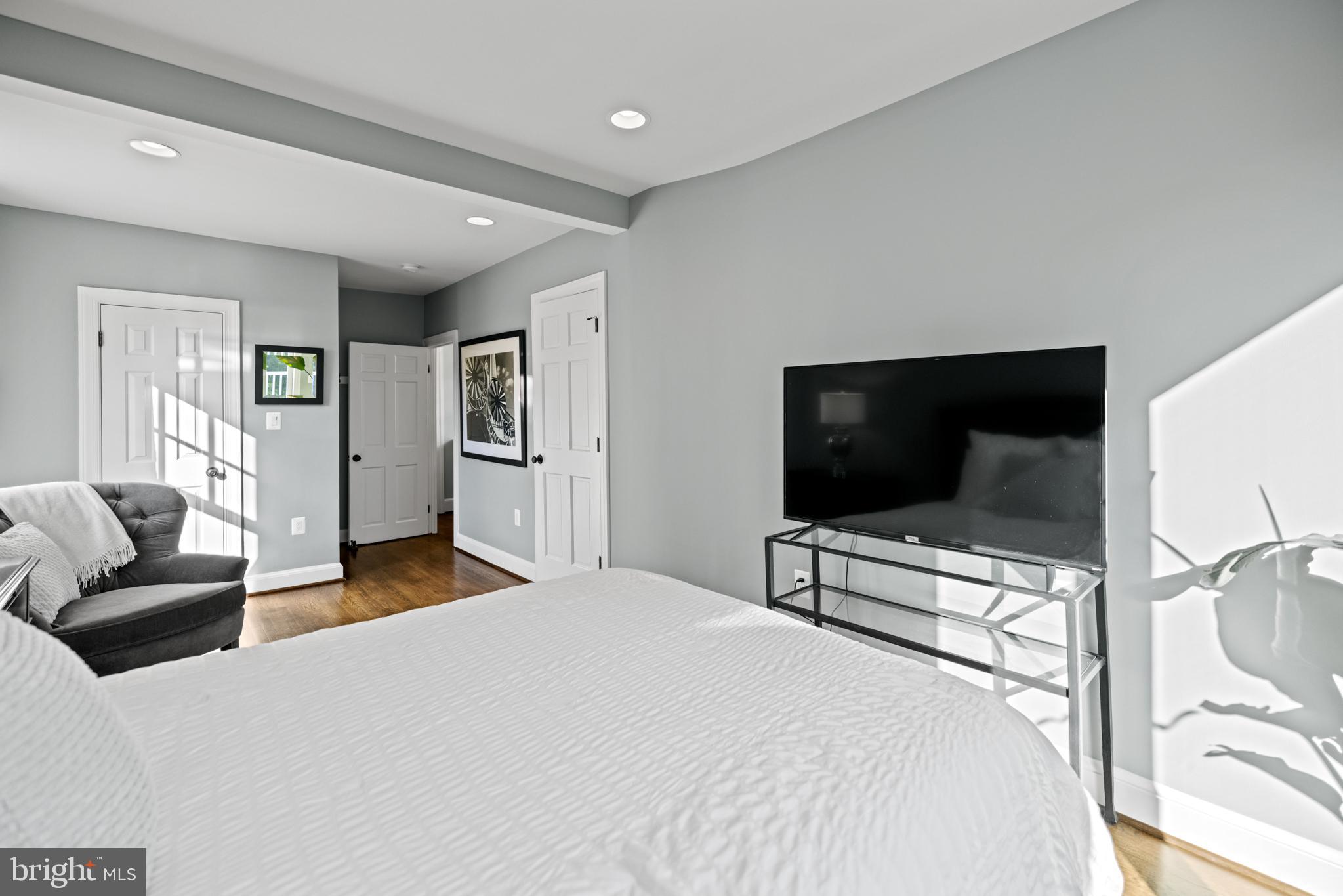 5212 MacArthur Boulevard Northwest Washington, DC 20016 - Photo 25 of 59 a bedroom with a bed and glass wall