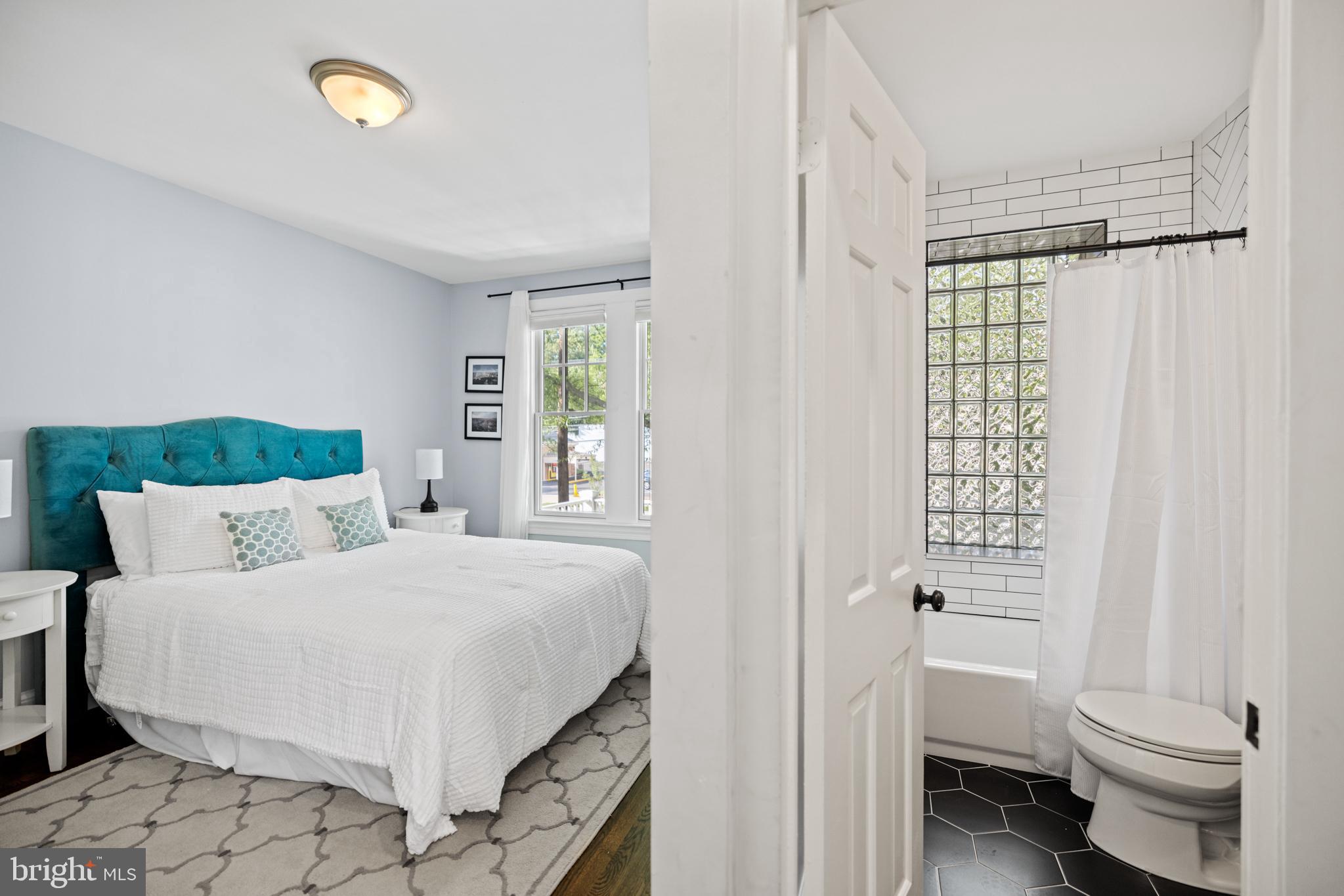 5212 MacArthur Boulevard Northwest Washington, DC 20016 - Photo 31 of 59 a bedroom with a bed and a window