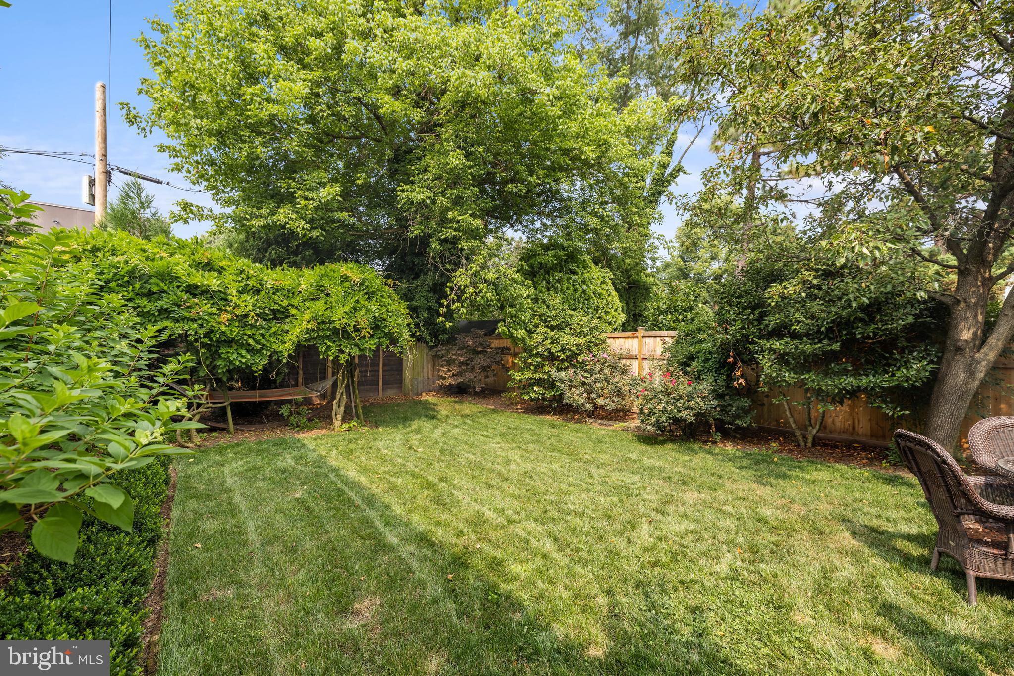 5212 MacArthur Boulevard Northwest Washington, DC 20016 - Photo 39 of 59 a backyard of a house with table and chairs