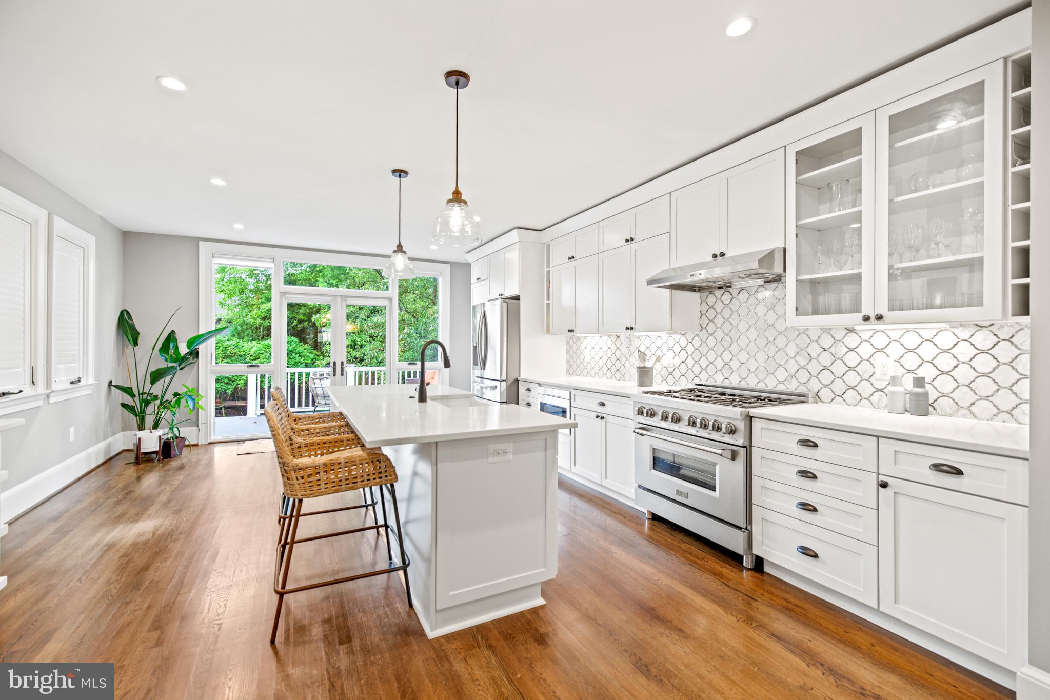5212 MacArthur Boulevard Northwest Washington, DC 20016 - Photo 5 of 59 a open kitchen with granite countertop white cabinets and stainless steel appliances