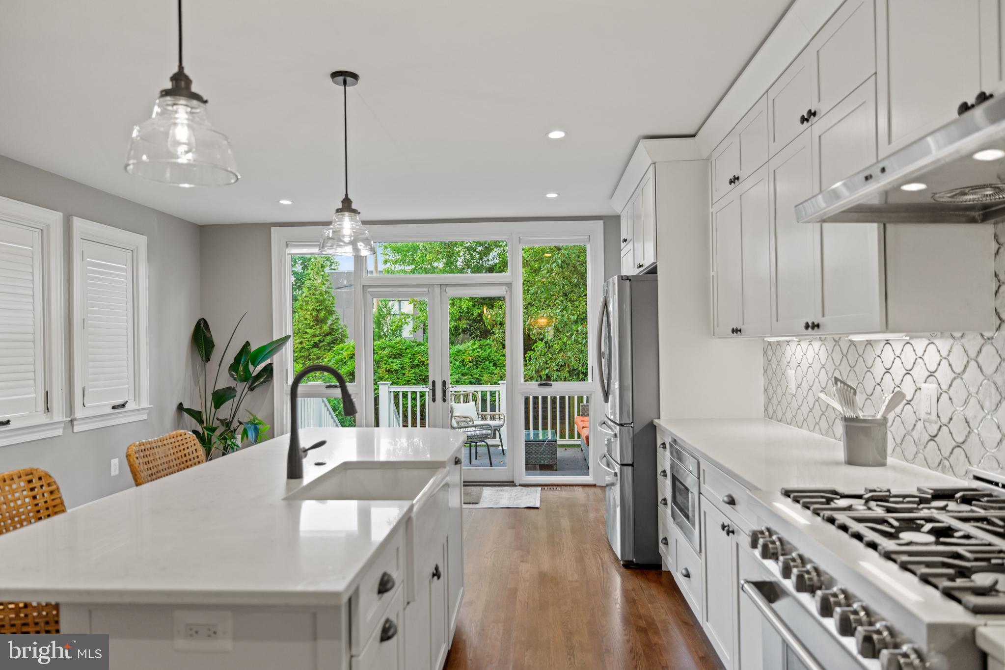 5212 MacArthur Boulevard Northwest Washington, DC 20016 - Photo 7 of 59 a kitchen with stainless steel appliances granite countertop a stove and a wooden floors