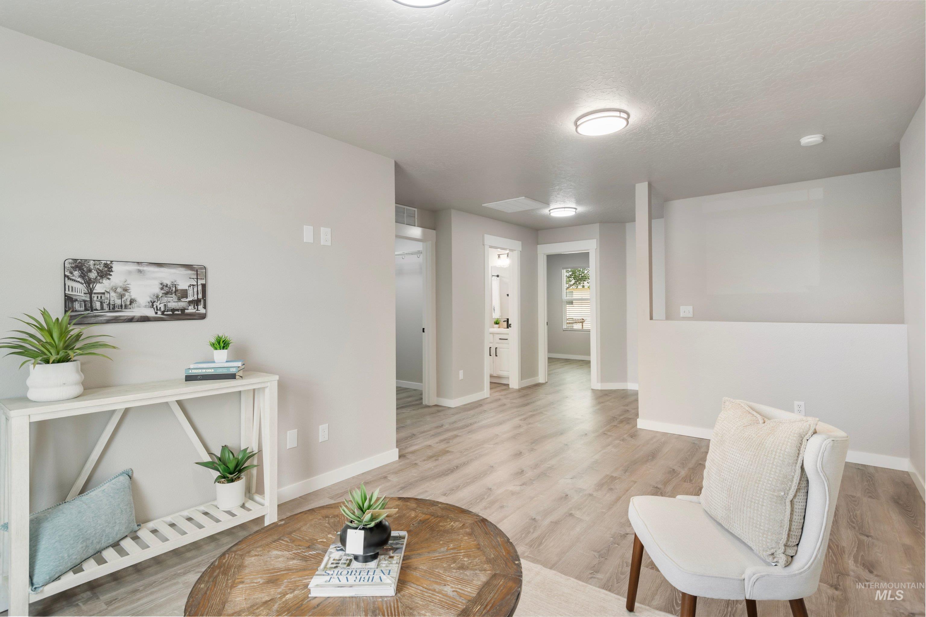 16759 Abram Avenue Caldwell, ID 83607 - Photo 25 of 33 Spacious room featuring wood-finish flooring, light gray wall paint, white trim, and recessed lighting
