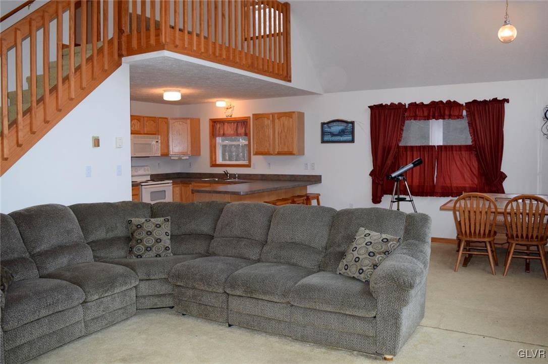 290 Brier Crest Road Blakeslee, PA 18610 - Photo 5 of 43 a living room with furniture and a lamp