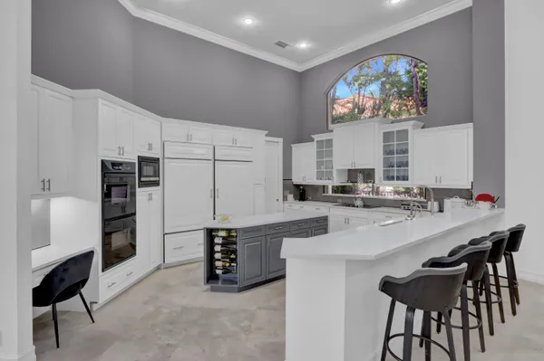 a kitchen with stainless steel appliances a microwave a stove and white cabinets