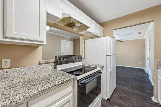a kitchen with a stove and a refrigerator
