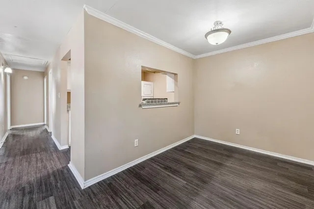 a view of room with wooden floor and window