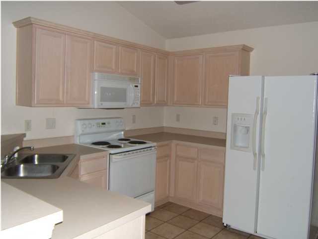 17 East Poplar Way Santa Rosa Beach, FL 32459 - Photo 3 of 9 a kitchen with a sink a stove and refrigerator