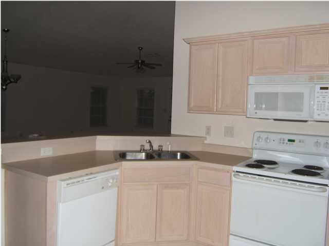 17 East Poplar Way Santa Rosa Beach, FL 32459 - Photo 4 of 9 a kitchen with appliances a sink and cabinets
