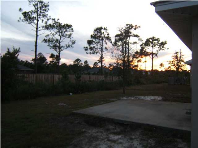 17 East Poplar Way Santa Rosa Beach, FL 32459 - Photo 9 of 9 a backyard of a house with lots of green space
