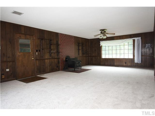4317 Jimmy Rogers Road Durham, NC 27703 - Photo 21 of 25 Living Room #1 with one of two wood burning stoves Living Room