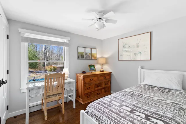 a bedroom with a bed and a table in it